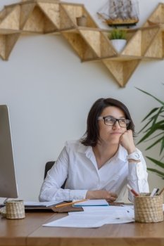 Woman thinking at her workplace