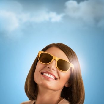 Happy young woman posing over blue sky