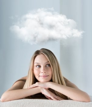 Beautiful young woman at a spa salon dreaming with thoughts cloud overhead