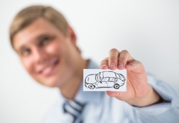 Young businessman holding sign with car sketch. Automobile dealer or credit agent
