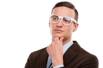 Young thoughtful businessman wearing glasses and holding chin on hand on white background
