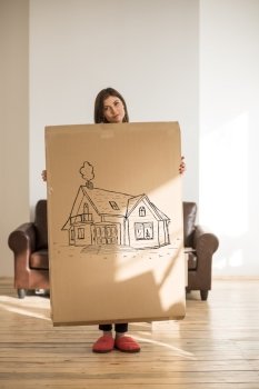 Mortgage and credit concept. Young woman relocating to new home and planning future