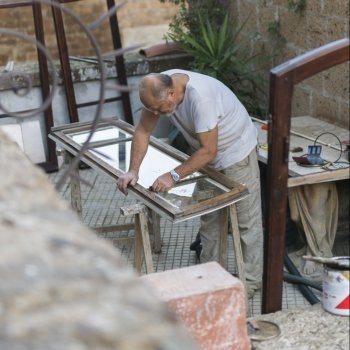 Carpenter preparing window in workshop, Orvieto, Terni Province, Umbria, Italy