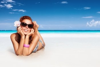 Nice girl relaxing on the beach, spending summer vacation on the spa resort, enjoying bright sunny day, photo with copy space
