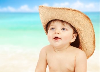 Closeup portrait of little naked cowboy wearing stetson hat over seascape background, happy child playing on the beach, joy and fun concept