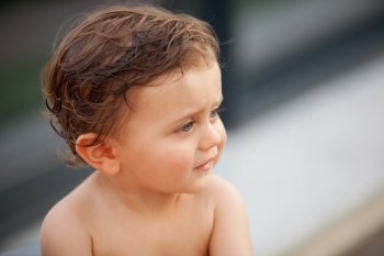 Beautiful baby one years old outside with wet hair
