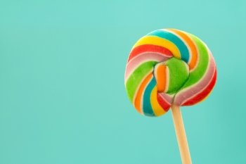Nice lollipop with many colors in a spiral on a blue background