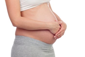 Beautiful pregnant belly isolated on a white background