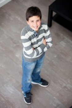 Preteen boy standing at home seen from above