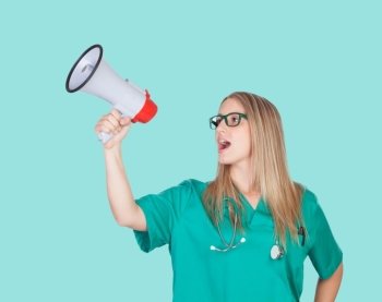 Atractive medical girl with a megaphone on a blue background