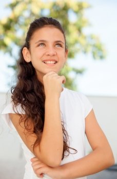 Pensive teenager girl with blue eyes smiling outside