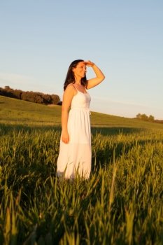 Relaxed brunette woman in the middle of meadow