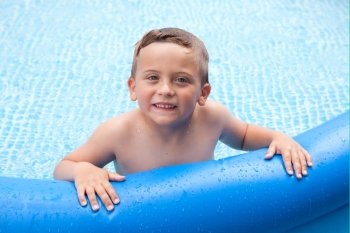Happy child in summer bathing in the pool