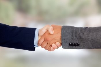 Handshake between businessmen with a unfocused background