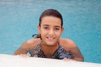 Pretty child girl swimming in the pool