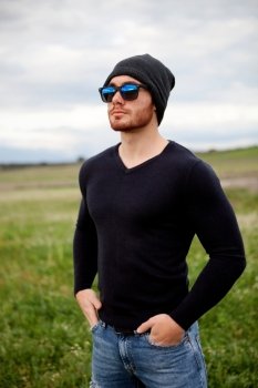 Handsome cool young man with sunglasses and cap wool
