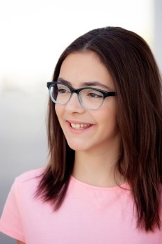 Pretty preteenager girl twelve years old with glasses outside 