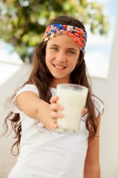 Teenager girl with blue eyes and a milk glass