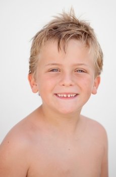 Funny blond boy looking at camera outside