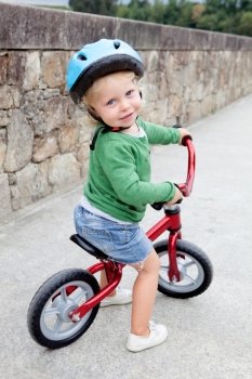 Little kid riding his bike down the street