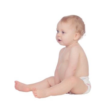 Adorable blonde baby in diaper sitting on the floor isolated on a white background