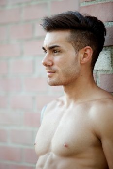 Handsome fit athletic shirtless young man with piercing on his nose