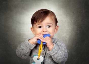 Little Boy Playing With Toy Key Over Coloured Background