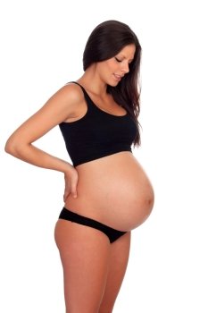 Attractive brunette pregnant in underwear with her hands in the kidneys isolated on a white background