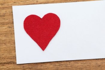 Blank sticky note with a red heart  