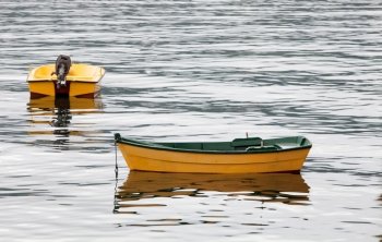 Couple of yellow boats floating on a calm sea