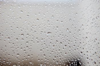 Photo of a glass full of water drops from rain