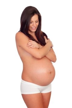 Beautiful body of a pregnant woman covering her bare chest with arms isolated on a white background