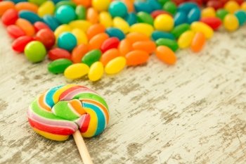 Colorful jelly beans and a round lollypop 
