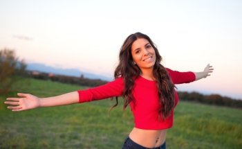 Beautiful young woman relaxing in the countryside with beautiful light