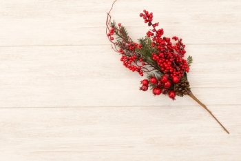 Red fruits on the branch Christmas for decoration on a wooden background