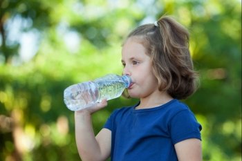 Cute little girl with water bottle in the park 