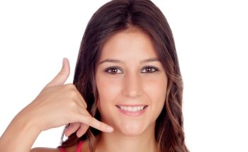 Smiling young woman making the gesture of  