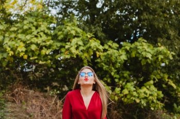 Pretty blonde girl with red clothes in the park