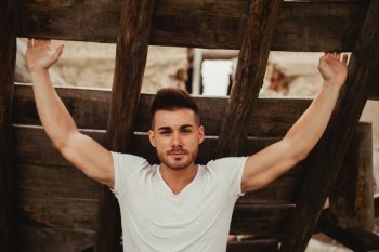 Attractive guy with white t-shirt in a old house. Image for ad
