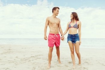 Romantic young couple on the beach. Portraits of romantic young couple standing on the beach