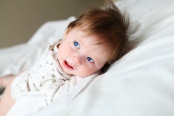 portrait of beautuful redhair infant with blue eyes