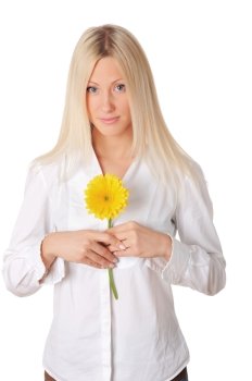 Young charming blonde is playing with a yellow flower isolated on white background