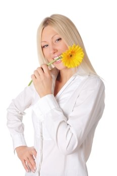 Young smiling blonde in a white shirt plays with a yellow flower in the hands