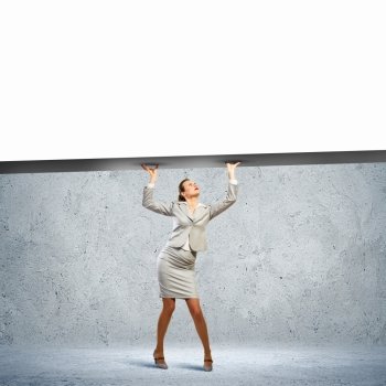 Businesswoman with banner. Businesswoman holding blank banner above head. Place for text