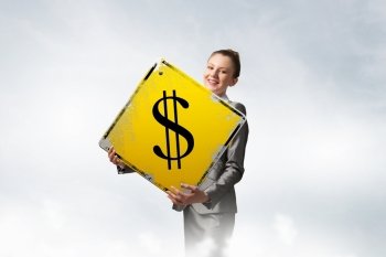 Your big interest rate. Young businesswoman holding sign with big dollar symbol in hands
