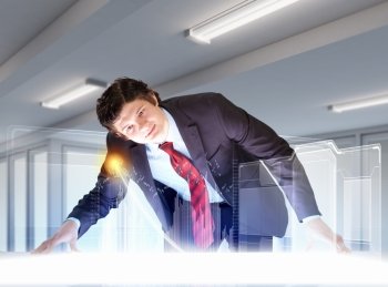 Business and innovation technologies. Image of young businessman looking at high-tech picture