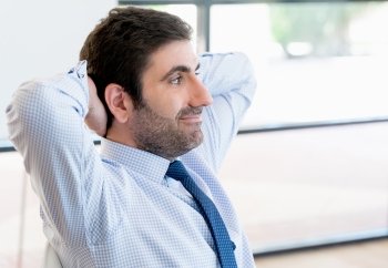 Businessman sitting and relaxing in office 
