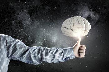 Human mind concept. Close up of businessman hand showing ok gesture and human brain