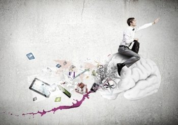 Conceptual image of young businessman riding human brain. Master of creativity