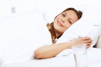 Portrait of a young smiling girl in bed